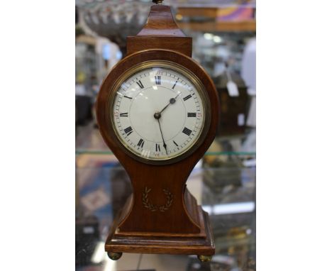 An Edwardian mahogany mantle clock, banjo form, on four ball feet 