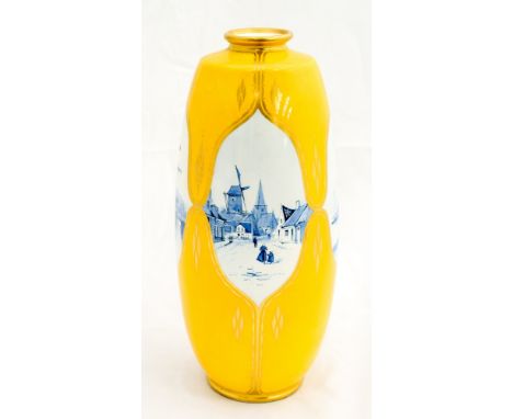 A yellow Minton vase shaped lamp base, having four cameo paintings in blue, signed by the artist, K Dean