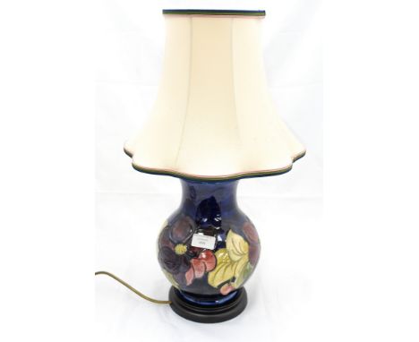 A Moorcroft 'Hibiscus' blue ground table lamp, complete with shade, approx 35cm high