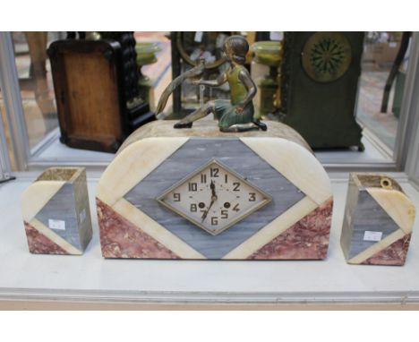An Art Deco clock with two book ends, key included 