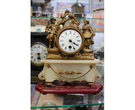A marble based mantle clock, having Ormolu figures with Roman numerals and red wooden base with pendulum 