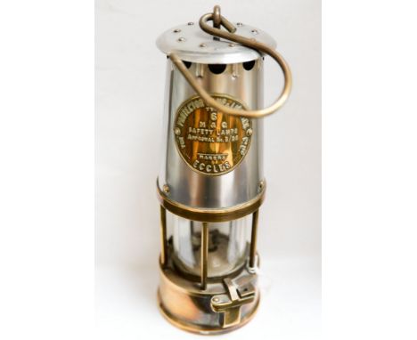 A late 19th Century miner's lamp, the front with a plaque stamped protector lamp and lighting type 6, Eccles 