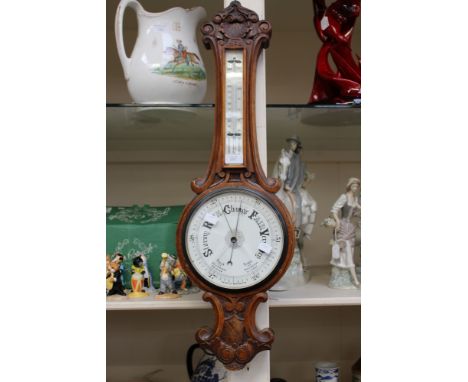 A late Victorian aneroid oak cased barometer (glass cracked)