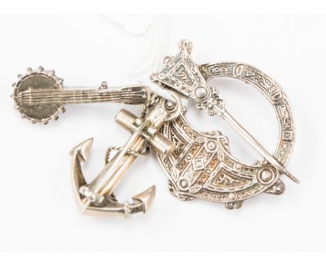 A silver cloak clasp Chester maker S & Co together with a silver hope anchor with agate decoration and silver banjo brooch, S