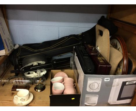 A shelf of assorted, to include golf clubs and ship in a bottle etc.