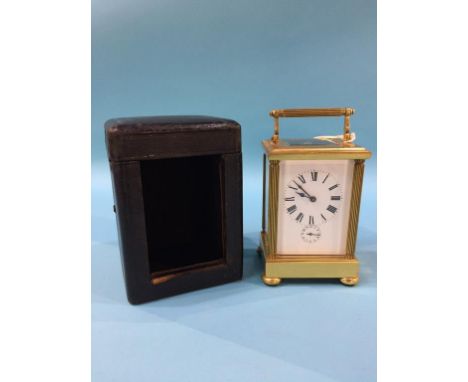 A brass carriage clock, in fitted leather case