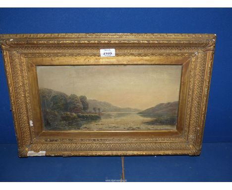 A gilt framed Oil on canvas depicting a river landscape with trees and distant hills under a soft muted sky, indistinctly sig