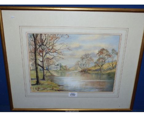 A framed and mounted Watercolour of a river landscape with Abbey ruins on the left, signed Ineson, 22 1/4" x 18 1/4".