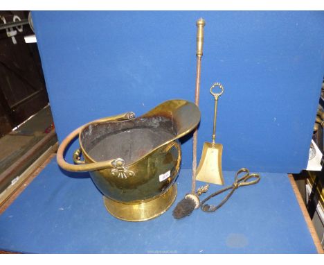 A Brass helmet coal Scuttle with tongs, poker, etc.