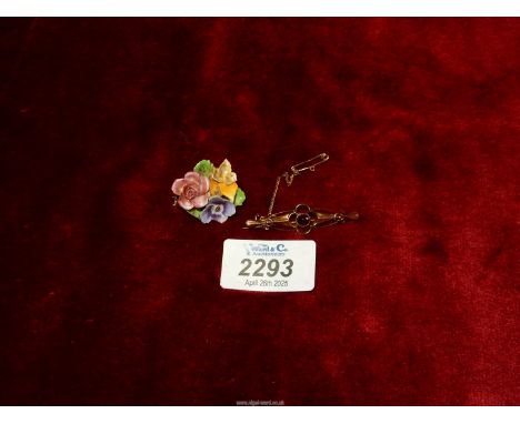 A 9ct rose gold brooch with red garnet and safety chain (hallmarks rubbed), together with a china posy brooch (made in Englan