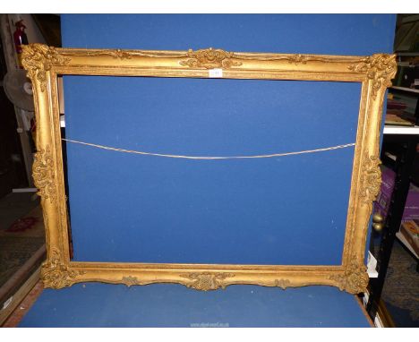 A large gilt picture frame overall size 41 1/2" x 29" , Aperture 36 1/4" x 24 1/4" a/f