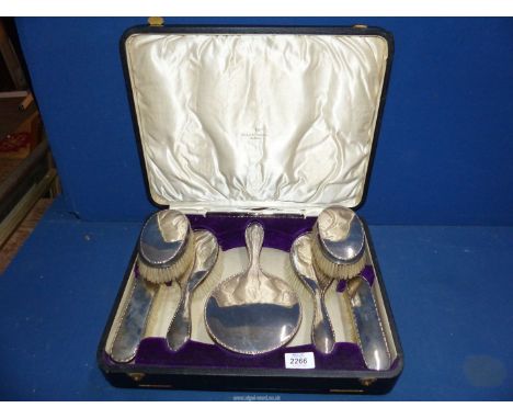 A presentation cased Silver backed dressing table set incl. two clothes brushes, two hair brushes and a hand mirror, Sheffiel