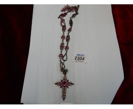A white metal Necklace, the 14" long chain with unusual pierced work links and set with a large number of pink "stones" and a
