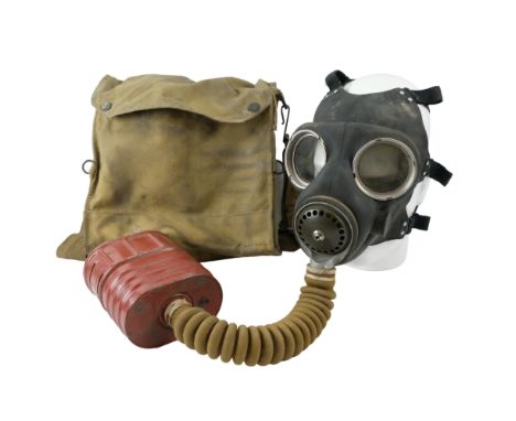 A Second World War British Army respirator, in haversack with eyeshields, First Field Dressing and first aid kit