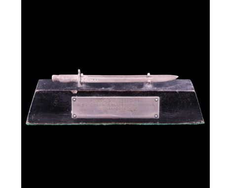 A 1926 Army bayonet training prize, being a silver miniature bayonet and ebonised stand with engraved plaque, 16 cm