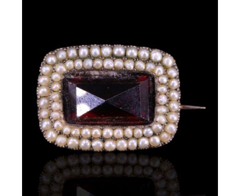 A Victorian garnet and seed pearl brooch the rectangular rose-cut stone set within two rings of millegrain-set pearls, the wh