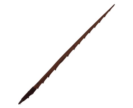 An ethnographic barbed wooden fishing/hunting arrow or spearhead, 64 cm
