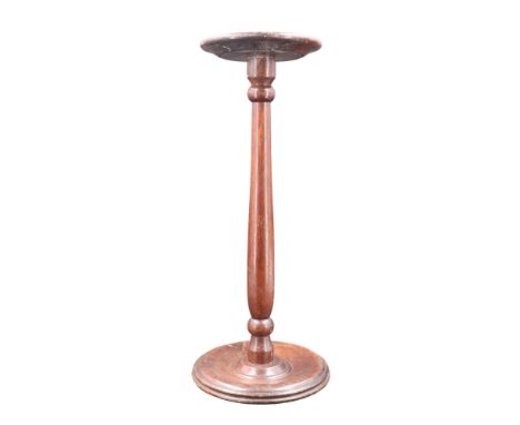 A late 19th / early 20th Century turned mahogany pedestal candlestick / stand, 46 cm