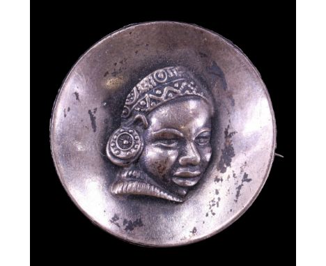 A late 20th Century South African Candida Sterling white metal brooch, of concave circular form decorated with a high-relief 