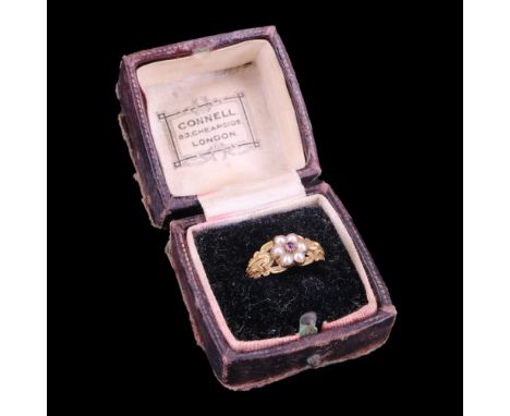 A Victorian pearl and purple topaz flower-head cluster ring comprising a small central round-cut stone, claw-set and framed b