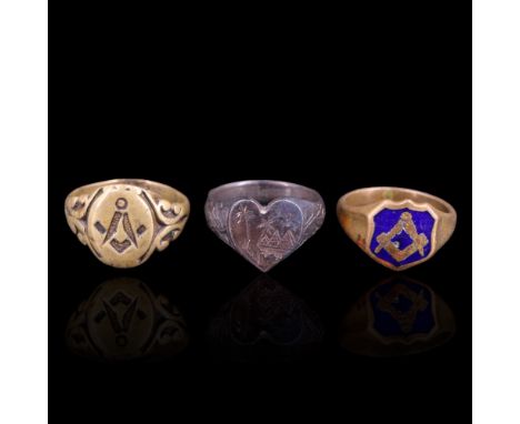 Two vintage Masonic signet rings together with an Egyptian ring, its heart-shaped face engraved in depiction of pyramids