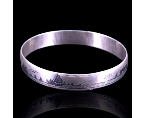 A Middle Eastern niello and white metal bangle, decorated in depiction of boats on a river with camels and figures ashore, ci