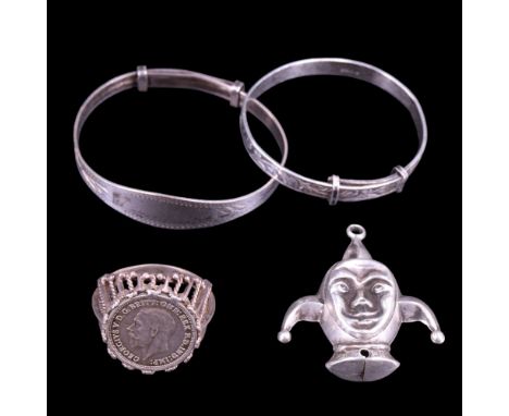 Two vintage silver children's bangles together with a rattle in the form of a jesters head, and a coin ring, 17 g
