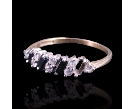 A sapphire and white stone ring comprising three baguette-cut sapphires of approx 1.5 cts aggregate weight, obliquely claw-se