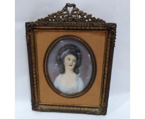 A French portrait miniature of a young lady, she wearing a lace trimmed low cut dress. The gilt metal frame. 6' high