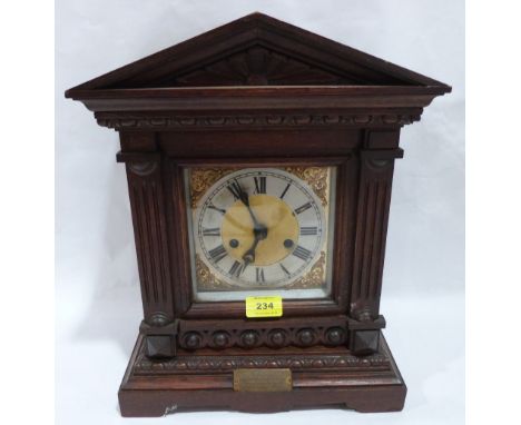 An early 20th century oak mantle clock in architectural case. 16' high