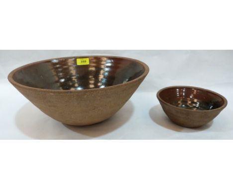Two St.Ives pottery bowls in the manner of Bernard Leach, the interiors glazed in shades of brown. Impressed mark 'f'. The la
