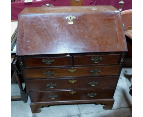 A George III fiddle back mahogany bureau, the sloping fall over a pair of short drawers and three long graduated drawers on b