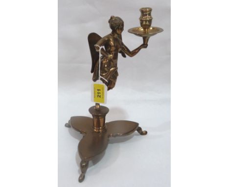 A brass figural angel candlestick on trefoil base. 11' high