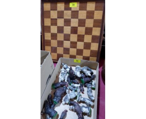 A chess set with treen board and resinous animal form pieces