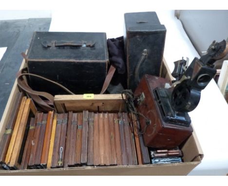 A box of Victorian camera plates, two leather cases and an early projector