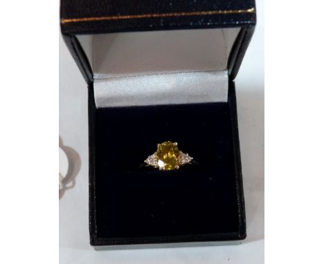 A green citrine and diamond ring. In gold marked 750. 2.7g gross. Size T