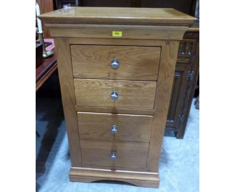 A light oak chest of four drawers on bracket support. 24' wide 