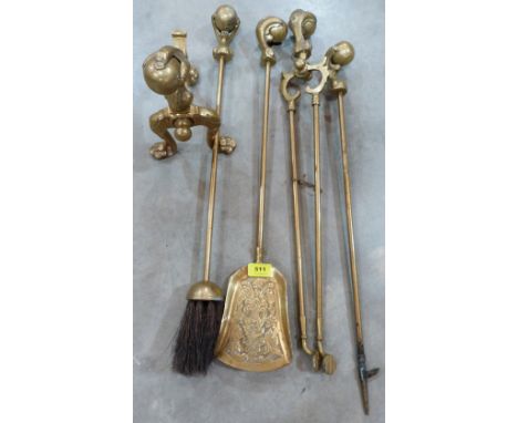 A four piece brass set of fire irons with ball and claw terminals, together with an andiron