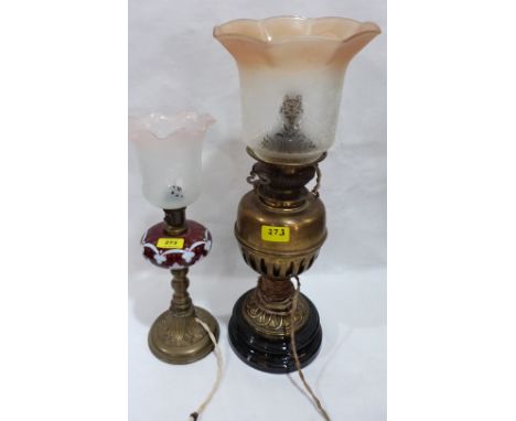 A late 19th century oillamp with ruby overlaid milchglass fount, together with a brass example, both converted for electric l