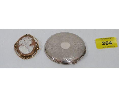 A silver engine turned powder compact and a shell cameo brooch