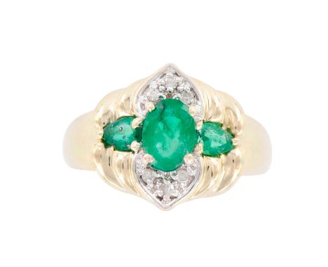 14k yellow gold ring. 7mm x 5mm oval emerald center with two pear cut emeralds on either side and six brilliant cut diamonds.