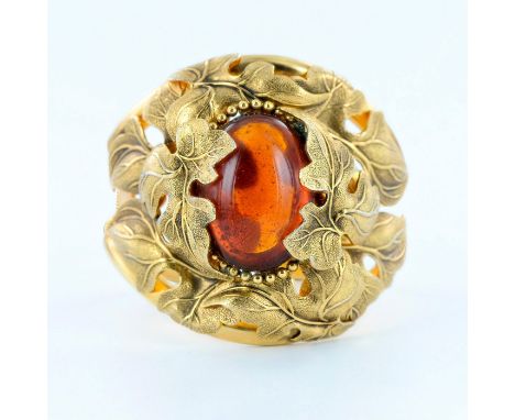Art Nouveau style ladies bracelet with gold tone floral ornaments and huge amber glass cabochon in the center. Measures 2.5" 
