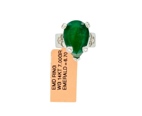 Gorgeous tear drop design ladies statement ring with a 6.70cts emerald and 10pc round brilliant cut diamonds. Weight 7.00 gra