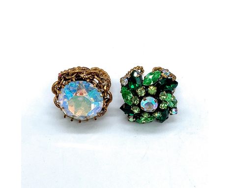 Ring 1: Large iridescent rhinestone with chain link border and Made Austria stamped inside. Ring 2: floral pattern with clear