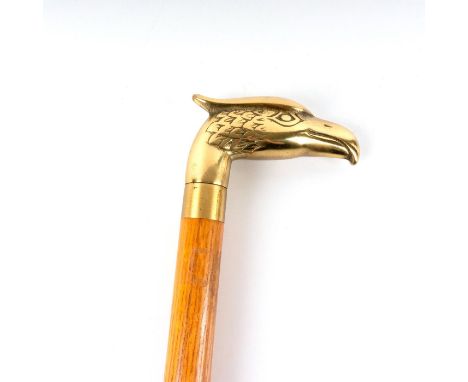 Wood shaft with light brown finish, dark grain, and black ring detail midshaft. Polished brass eagle head handle.Small black 