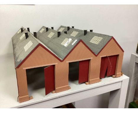 An OO Gauge three track engine shed with red barn doors, playworn (not all doors present).