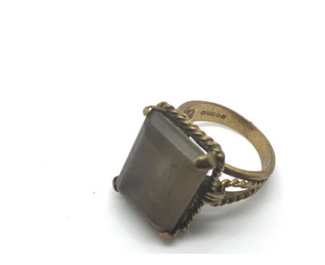 A 9ct gold ring set with a smoked Quartz, 7.5g total weight.