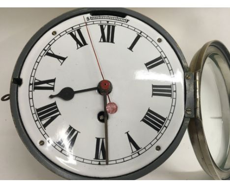 A brass ships clock in working order. Key wind fusse movement and enamel dial.