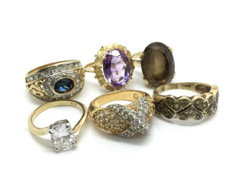 A collection of six stone set dress rings to include a central set white stone ring, a 'x' ring and a heart band ring.