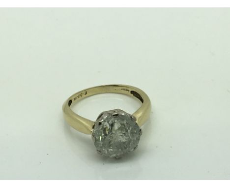 A large Brilliant cut (6.51 carat) diamond solitaire ring. Set in yellow 18ct gold. The impressive size diamond with visible 